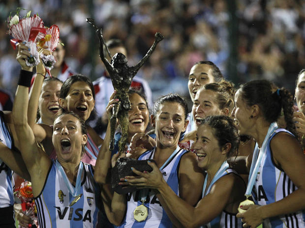 Argentina's Luciana Aymar, center, holds up the Champions Trophy 
