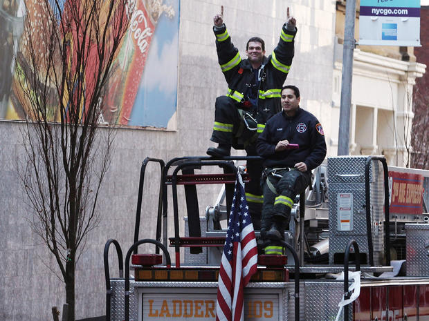 A fireman raises his hands in celebration 