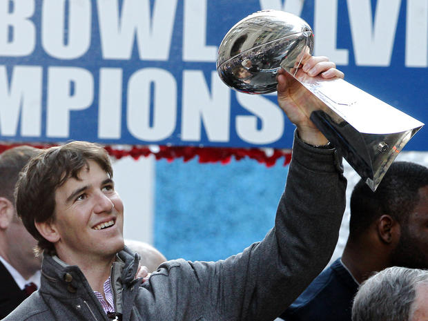 Eli Manning holds up the Vince Lombardi Trophy  