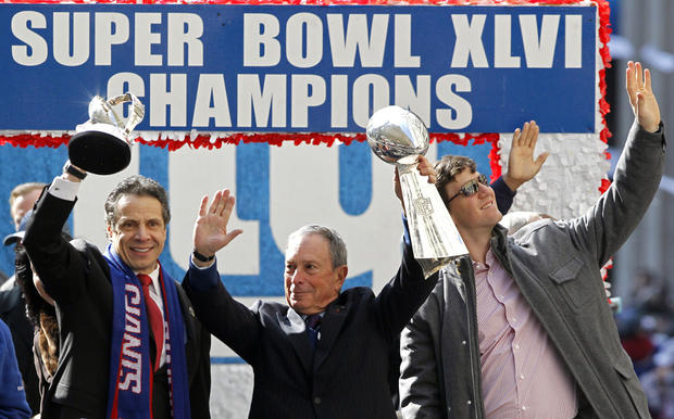 Andrew Cuomo, Michael Bloomberg and Eli Manning 
