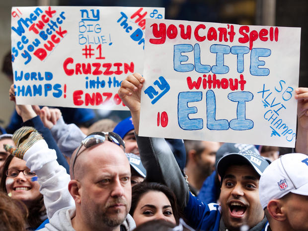 Giants fans holds up signs and cheer 