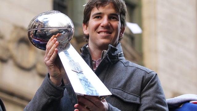 Eli Manning holds the Vince Lombardi Trophy 