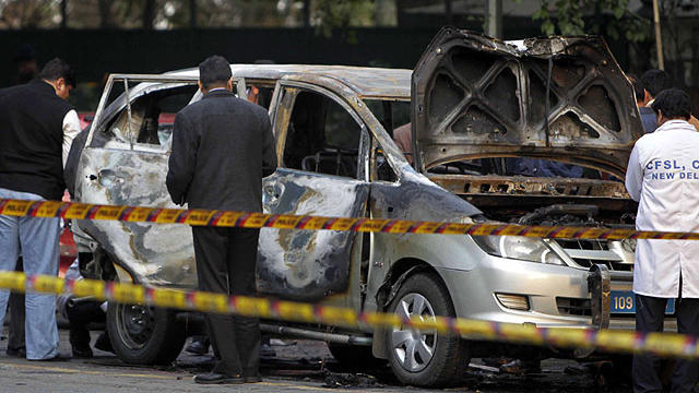 Indian security and forensic officials examine a car belonging to the Israel Embassy after an explosion tore through that in New Delhi, India, Feb. 13, 2012.  