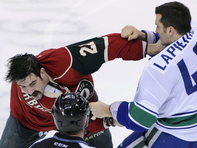 Cal Clutterbuck ducks a punch from Maxim Lapierre 