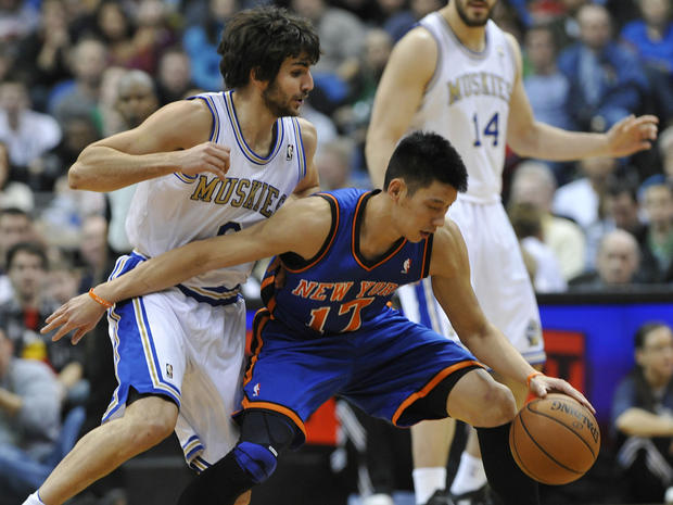 Jeremy Lin keeps the ball out of reach of Ricky Rubio 