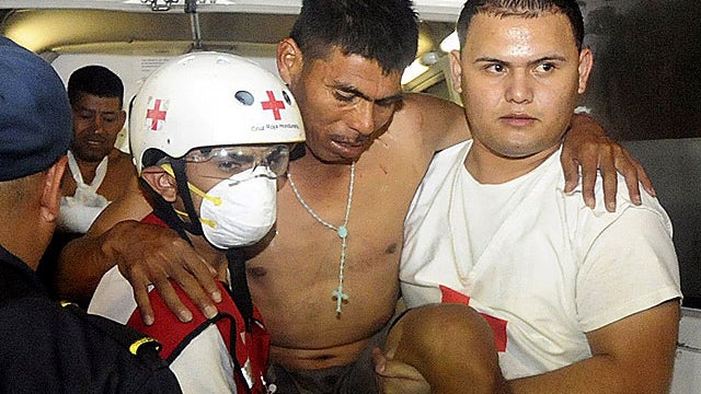 An injured inmate is carried as he arrives at the hospital after a fire broke out at the prison in Comayagua, Honduras, a town 90 miles north of the Central American country's capital, Tegucigalpa, early Wednesday, Feb. 15, 2012.  