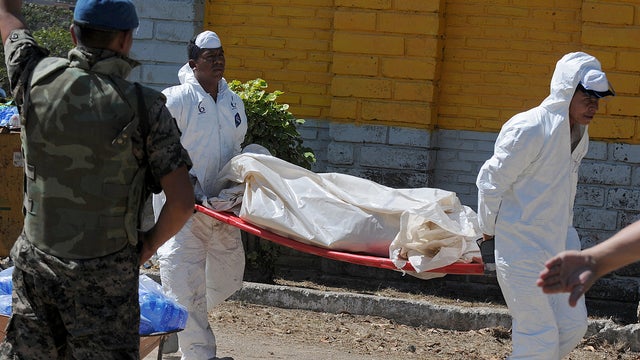 An injured inmate is carried as he arrives at the hospital after a fire broke out at the prison in Comayagua, Honduras, a town 90 miles north of the Central American country's capital, Tegucigalpa, early Wednesday, Feb. 15, 2012.  