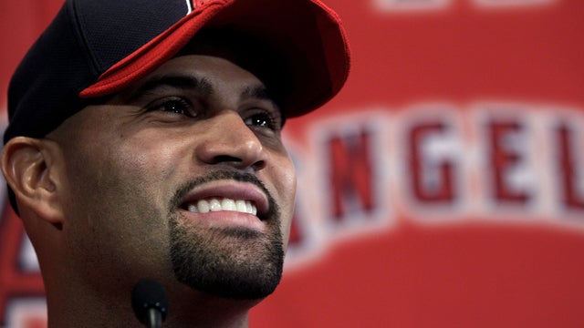 Albert Pujols smiles during a news conference 