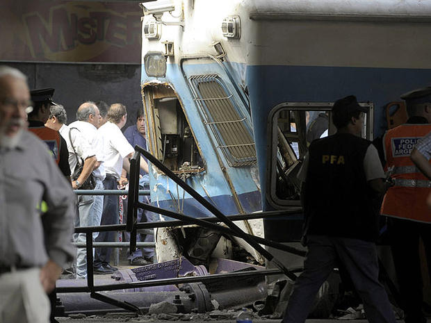 Police and rescue workers surround a train that crashed at Once train station in Buenos Aires on February 22, 2012. 