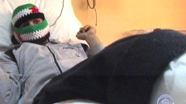 Flames rise from a house from Syrian government shelling, at Baba Amr neighborhood in Homs province 