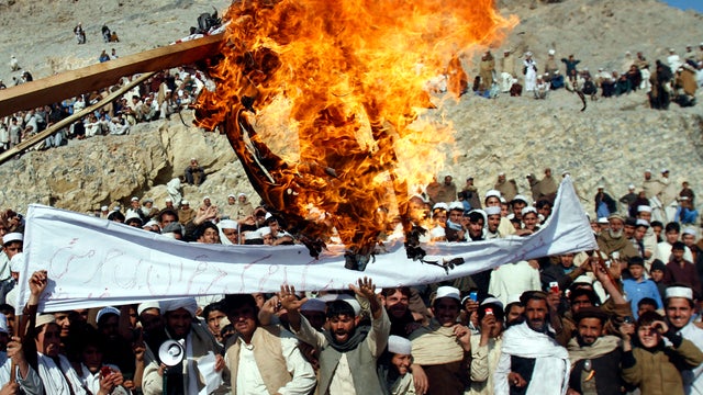 Afghans burn an effigy representing President Obama in Ghani Khail, Afghanistan, Feb. 24, 2012, during an anti-U.S. protest over the burning of Korans at a military base. 