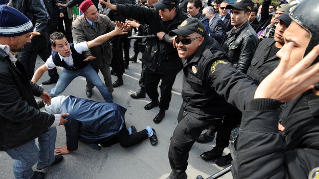 Tunisian police wielding batons beat back several dozen protesters trying to enter the venue of an international meeting on the Syria crisis in Tunis Feb. 24, 2012. 