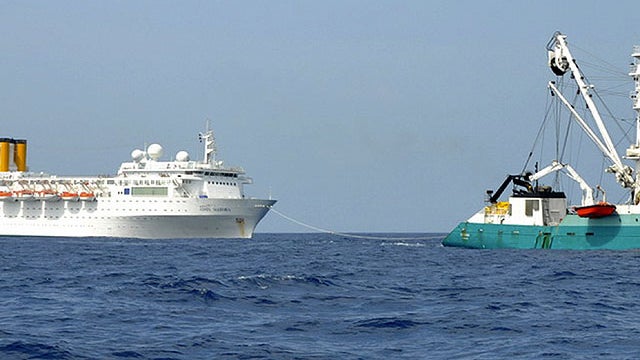 In this photo taken by a member of French fishing vessel, The Talenduic, and provided by the Prefecture of the Reunion Island, shows the Italian cruise ship, The Costa Allegra, left, being towed by French fishing vessel, The Trevignon, in the Indian Ocean 