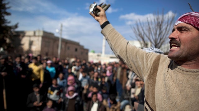 A man reacts during a funeral of people killed in clashes with government forces in Sarmin, Syria, Feb. 28., 2012.  