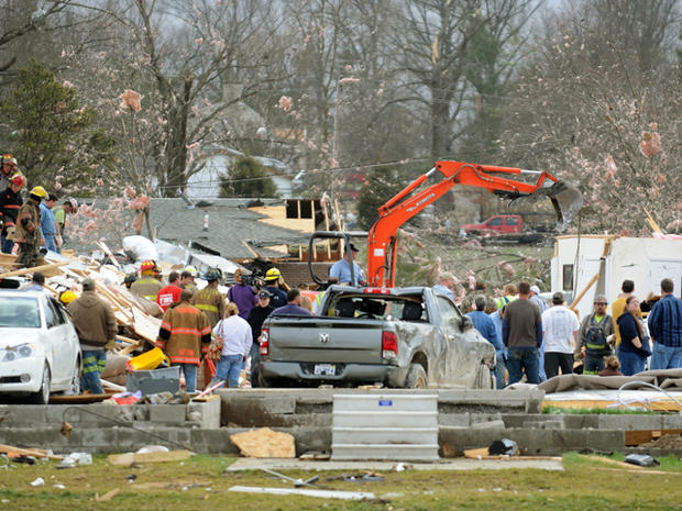 Emergency responders work to clear debris in a neighborhood in Harrisburg, Ill., after an early morning tornado Wednesday, Feb. 29, 2012. 