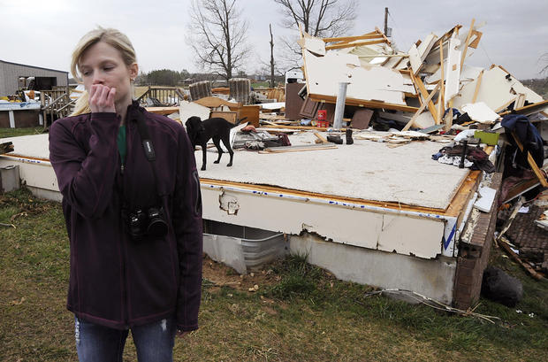 Lindsey Kidd surveys the damage to her boyfriend's parents' home 