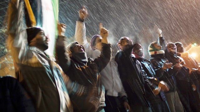 Free Syrian Army supporters chant anti government slogans under snowfall on the outskirts of Idlib 
