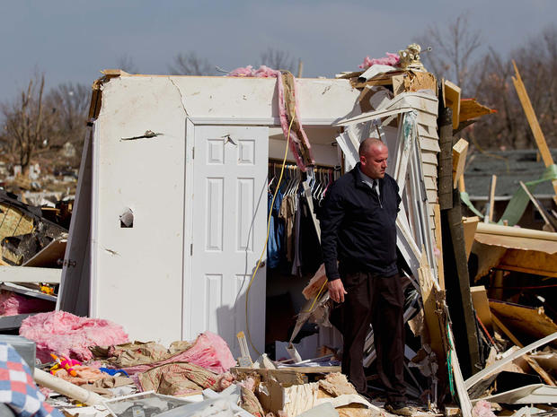 Steve McDonald stands debris from the home 