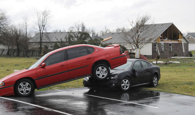 A car is perched on top of another following severe weather 