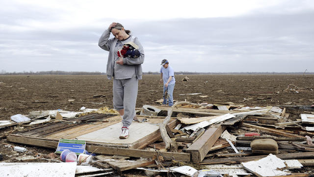 Judy Hudnall sift through the debris left  