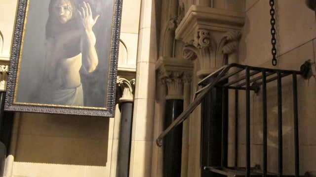 The iron cage that housed the heart of St. Laurence O'Toole sits broken and empty March 4, 2012, inside Christ Church Cathedral in Dublin. A modern portrait of Jesus Christ is in the background.The iron cage that housed the heart of St. Laurence O'Toole s 