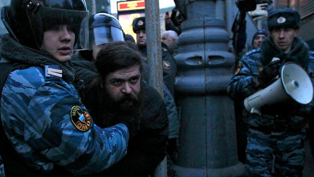 Russian police officers detain an opposition protester during a protest near the Central Election Committee in Moscow March 5, 2012. 