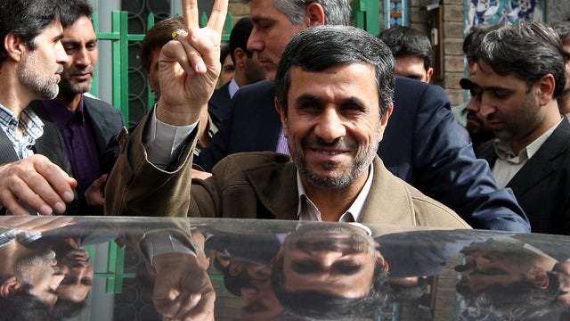 Iranian President Mahmoud Ahmadinejad makes the victory sign after voting at a polling station in Tehran March 2, 2012. 