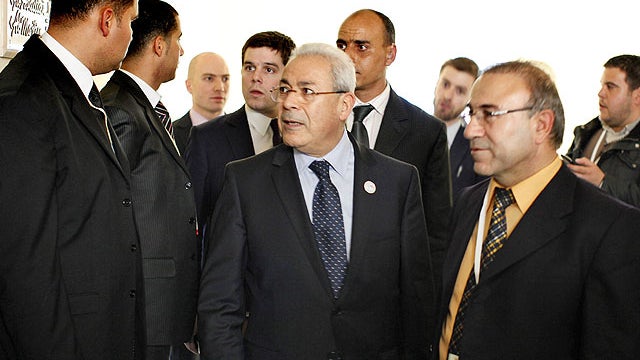 In this Feb. 24, 2012 file photo, Burhan Ghalioun, center, President of the Syrian National Council, walks to a bilateral meeting with U.S. Secretary of State Hillary Rodham Clinton, unseen, at the Friends of Syria Conference in Tunis. 