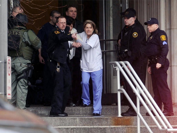 Police help employees of Western Psychiatric Institute and Clinic evacuate the building March 8, 2012, in Pittsburgh. 
