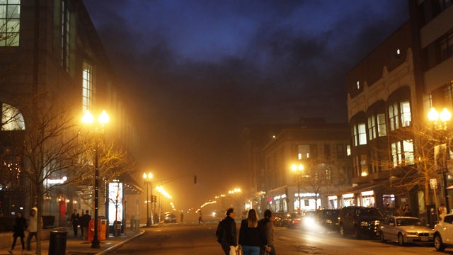Pedestrians walk on Bolyston Street as it is engulfed with smoke from an electrical transformer fire in Boston's Back Bay neighborhood Tuesday, March 13, 2012. There were no immediate reports of serious injuries but streets in and around the city were shu 