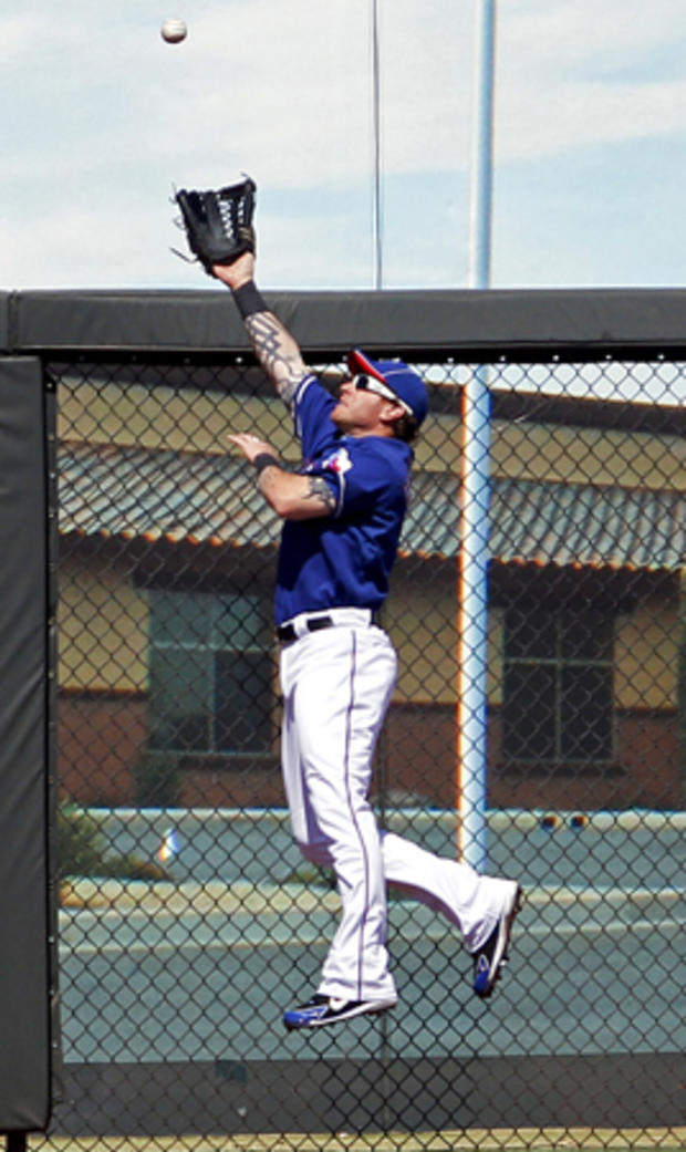 Josh Hamilton gets above the fence to catch a hit  