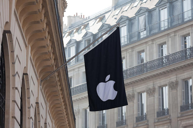 The Apple store in Paris sports the company logo on a flag. 