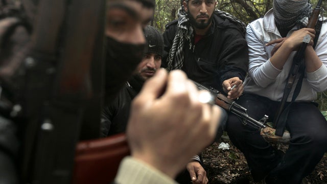 Armed Syrian men, members of the rebel Free Syrian Army, gather in a mountainous area of the restive Idlib province in northwestern Syria March 13, 2012. 