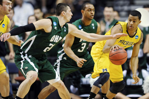 Ohio forward Ivo Baltic, second from left, swats the ball away from Michigan guard Trey Burke 