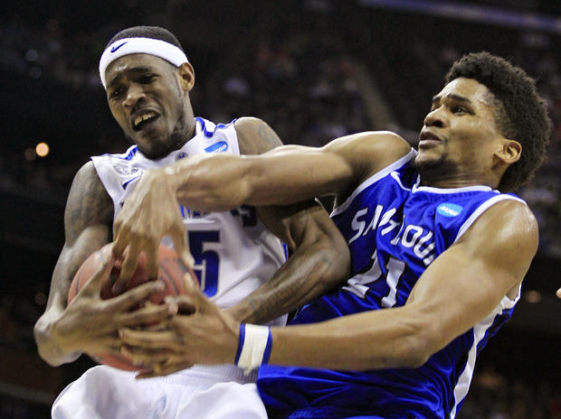 Memphis' Will Barton, left, is fouled by St. Louis' Dwayne Evans  
