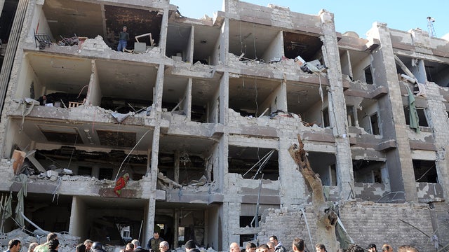 Syrian authorities at scene of one of two explosions in Damascus Saturday 