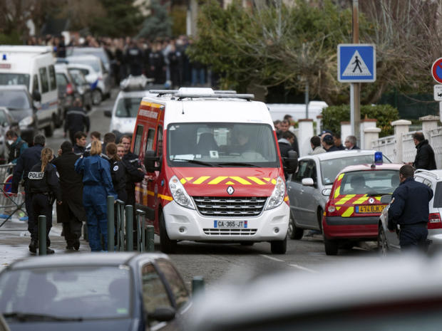 Officials gather at the site of a shooting in Toulouse 