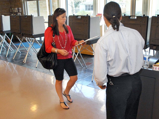 Molly Mintus of Bloomington, Ill. casts her ballot with help from election judge Mike Powell, at Trinity Lutheran Church, in Blooomington on Tuesday March 20, 2012. Voters around the state went to the polls for the Republican Party primary and other state and local races.