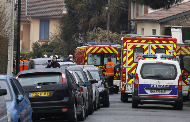 Ambulances and police vehicles are parked in the street of Toulouse  