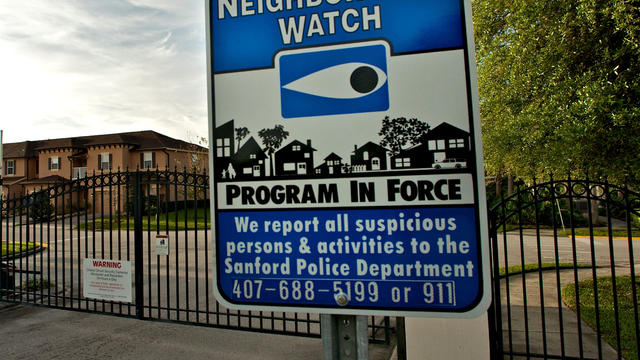 A Neighborhood Watch sign stands outside the gated The Retreat at Twin Lakes community March 20, 2012, in Sanford, Fla., where Trayvon Martin was shot by George Zimmerman while on Neighborhood Watch patrol. 