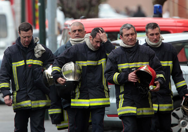 French firefighters leave after a police assault on a suspected Islamic extremist 
