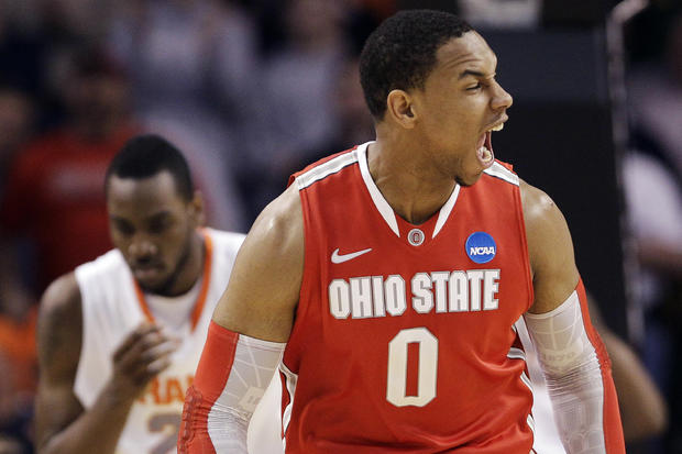 Jared Sullinger reacts in front of Syracuse forward Rakeem Christmas 
