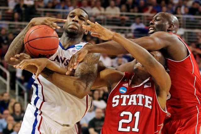 Thomas Robinson battles for a ball against C.J. Williams and center DeShawn Painter 