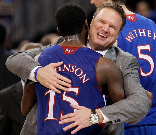 Kansas coach Bill Self celebrates with guard Elijah Johnson  