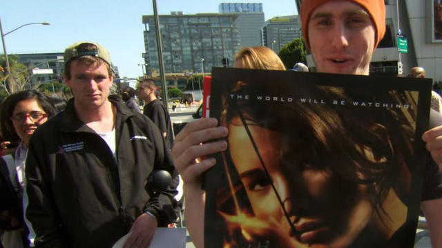 Fans show off their "Hunger Games" memorabilia. 