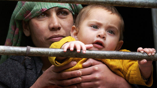 Woman looks out from Afghan prison cell with her baby son 