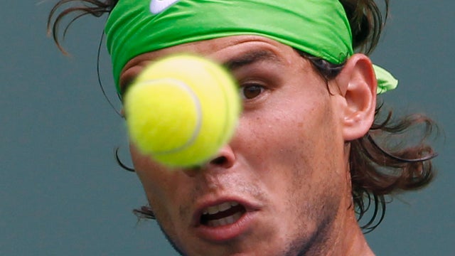 Rafael Nadal keeps his eye on the ball as he returns a shot from Kei Nishikori 