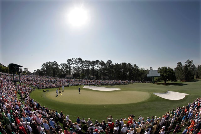 Tiger Woods putts on the 18th green 