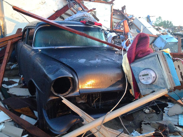 A vehicle is covered in tornado debris in Dallas 