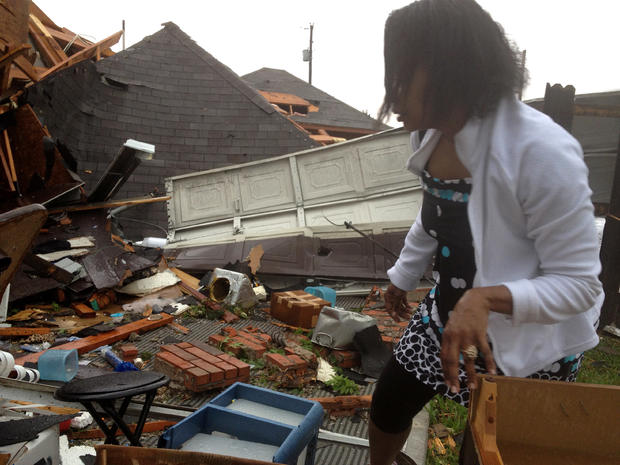 Jerica Jenkins surveys damage to her home after it was hit by a tornado 